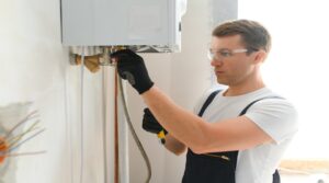 Professional boiler service: qualified technician checking a natural gas boiler at home